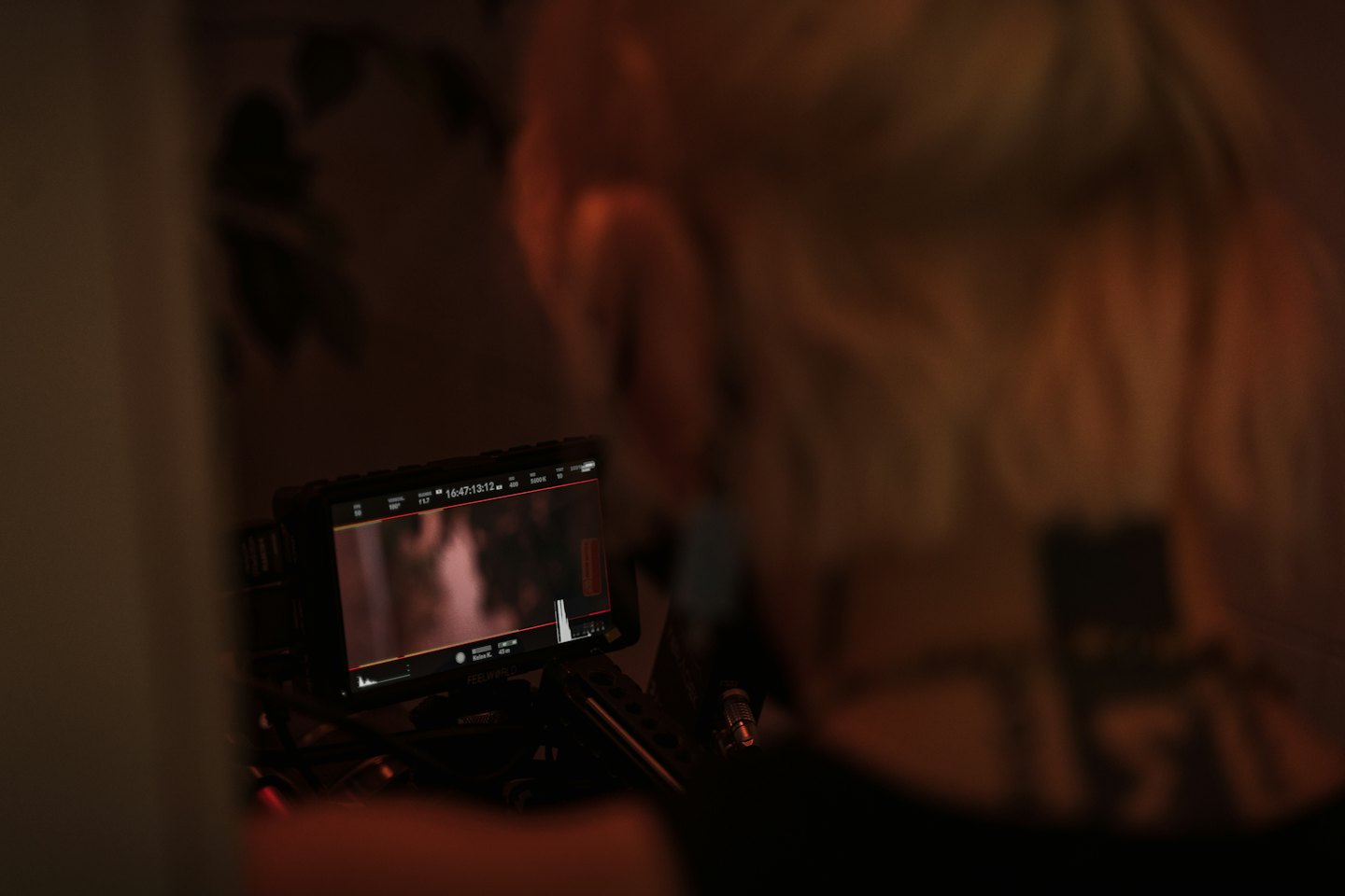 Video production monitor displays footage and technical data.